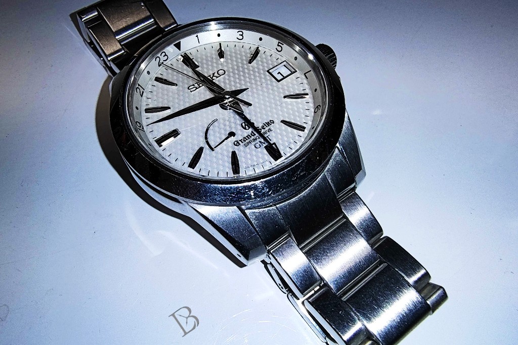 Grand Seiko SBGE009 Spring Drive GMT with a golf-ball-lookin' dial