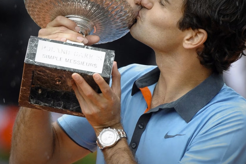 Roger Federer wears a Rolex Yacht-Master II in white gold while hoisting the 2009 French Open trophy