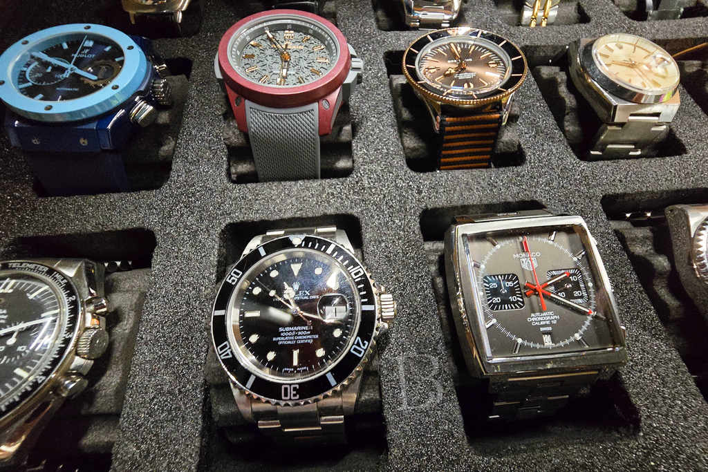 Watch box shot: various luxury sports watches from Hublot, Norqain, Rolex etc.