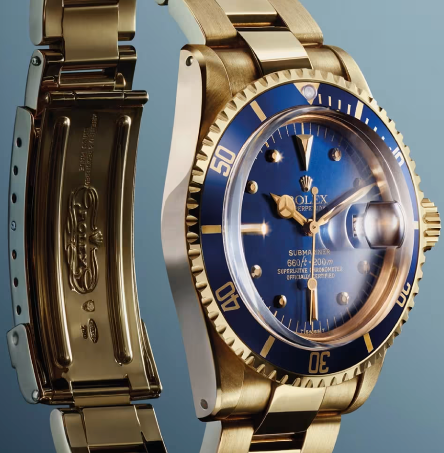 The first gold Rolex Submariner, ref. 1680/8, shown here with a blue dial and bezel insert.