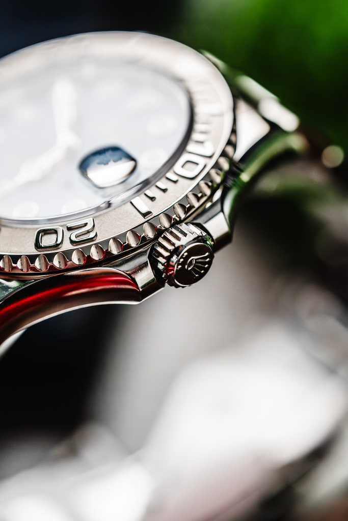 Side-angle close-up of a Rolex Yacht-Master 40 showing the raised Cyclops magnifying lens on the watch crystal.