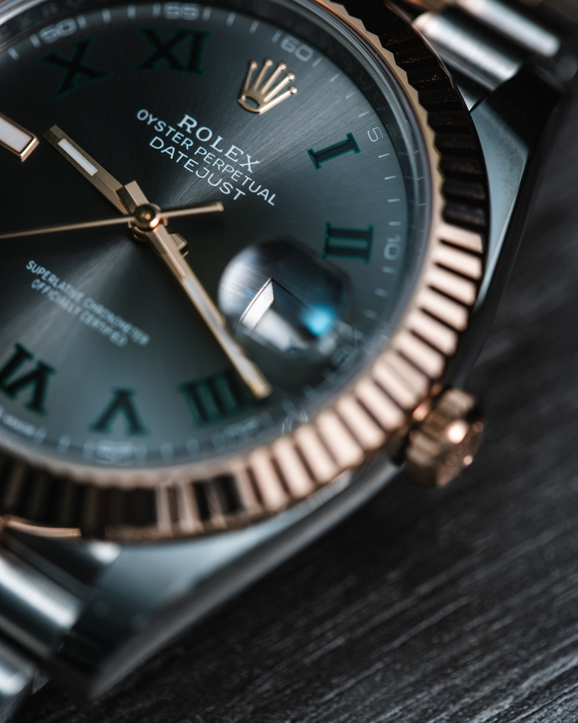 Close-up of a two-tone Rolex Datejust 41 with a Wimbledon dial, fluted bezel, and raised Cyclops date magnifier.